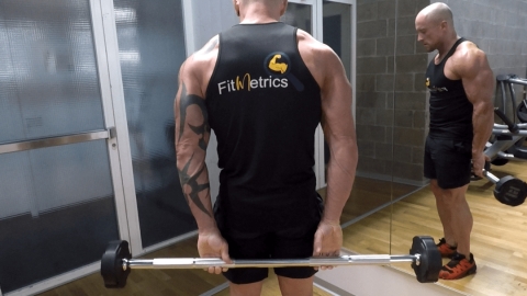 Image Flessione dei polsi con bilanciere dietro la schiena